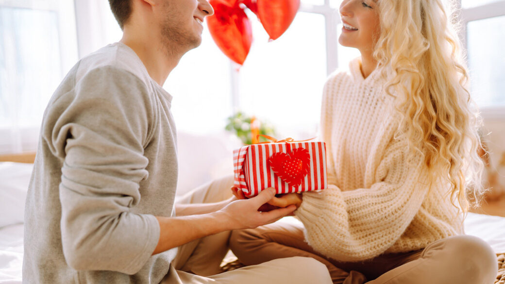 Valentine's day couple exchanging gifts