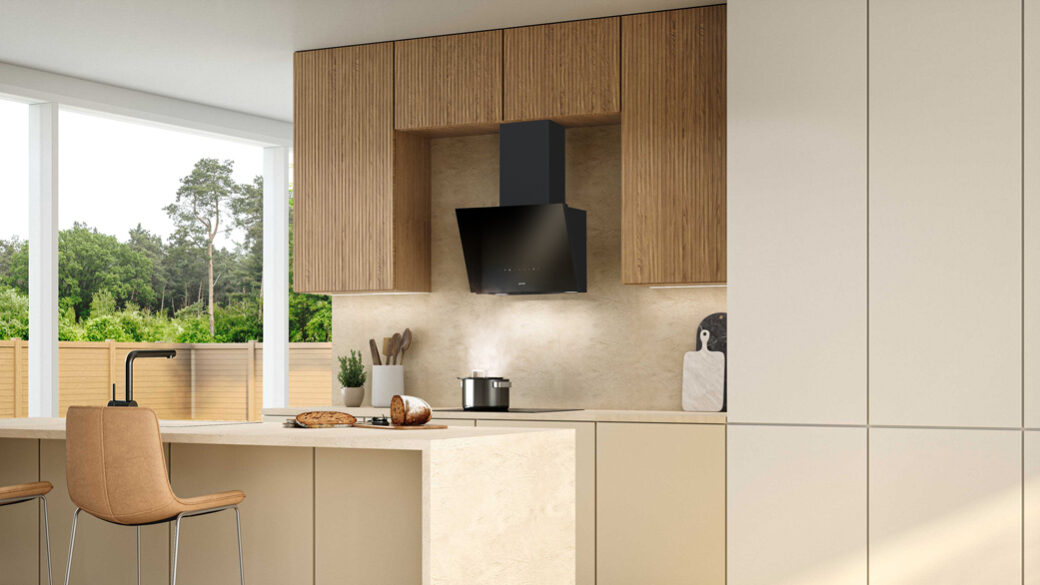 Modern kitchen interior with a sleek black Gorenje G600 hoods, surrounded by light wood cabinets and soft neutral tones.
